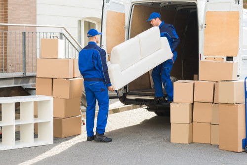 Worker lifting a box safely during a moving service