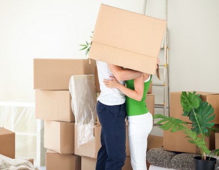 Packed household boxes and wrapped furniture ready for transport